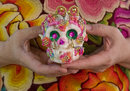 angela villalba holding a sugar skull